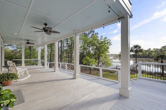 deck featuring a water view and a ceiling fan