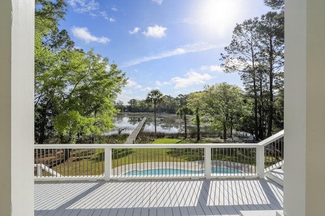 deck featuring a water view and an outdoor pool