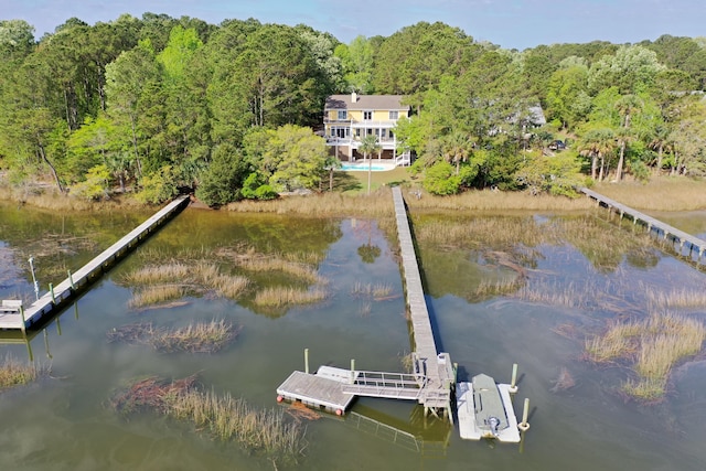 dock area with a water view and a wooded view