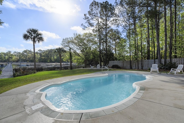 view of pool with a fenced in pool, a yard, a patio, and fence