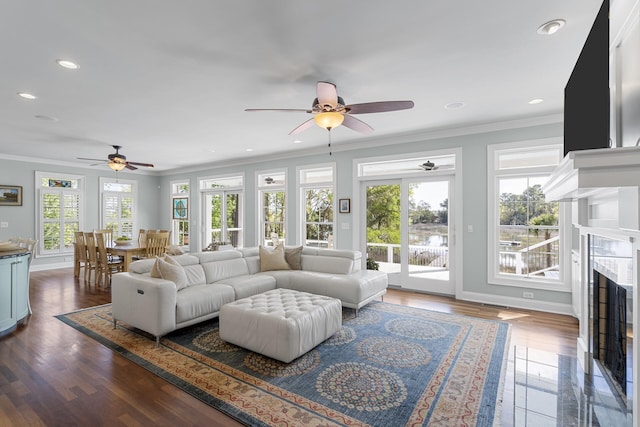 living room with baseboards, ornamental molding, ceiling fan, a fireplace, and recessed lighting