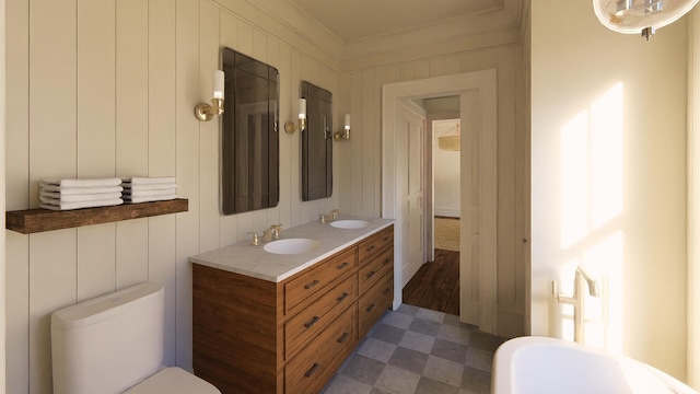 full bathroom featuring double vanity, toilet, a sink, and tile patterned floors