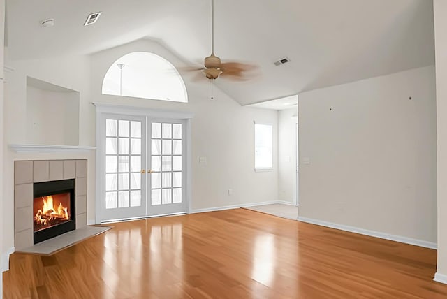 8800 Dorchester Rd Unit 2004, North Charleston, SC 29420 - unfurnished living room featuring a ceiling fan, wood finished floors, a tiled fireplace, and lofted ceiling