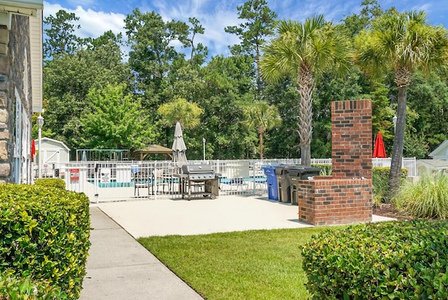 8800 Dorchester Rd Unit 2004, North Charleston, SC 29420 - view of patio / terrace with grilling area, a community pool, and view of wooded area