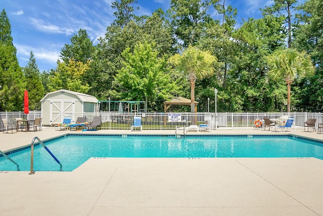 8800 Dorchester Rd Unit 2004, North Charleston, SC 29420 - community pool with a patio area, view of wooded area, and a shed
