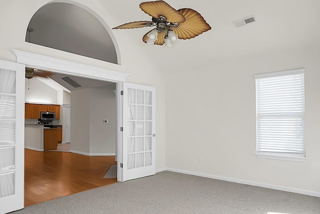 8800 Dorchester Rd Unit 2004, North Charleston, SC 29420 - carpeted spare room featuring a ceiling fan, vaulted ceiling, french doors, and plenty of natural light