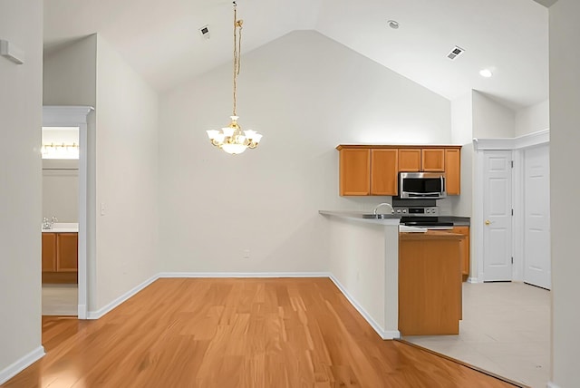 8800 Dorchester Rd Unit 2004, North Charleston, SC 29420 - kitchen with stainless steel appliances, a chandelier, light wood-style flooring, a peninsula, and high vaulted ceiling