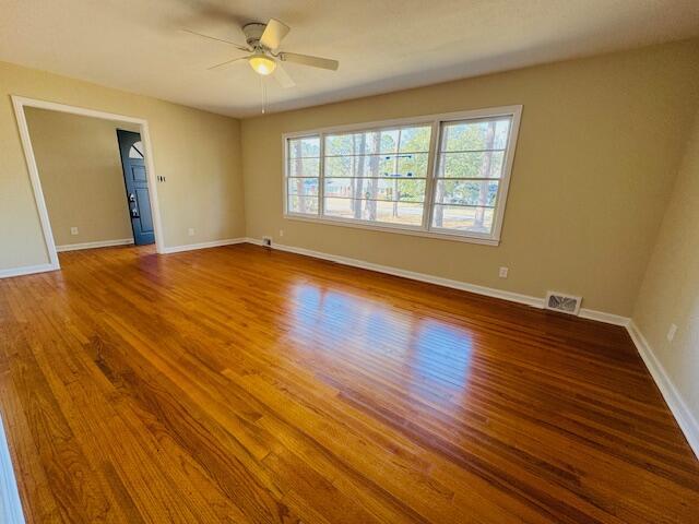 spare room with hardwood / wood-style floors and ceiling fan