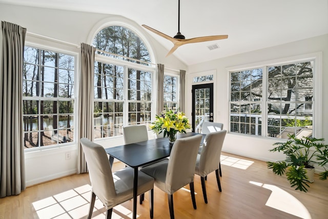 sunroom / solarium with lofted ceiling, a wealth of natural light, and ceiling fan