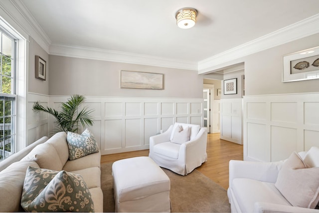 living room featuring crown molding and light wood-type flooring