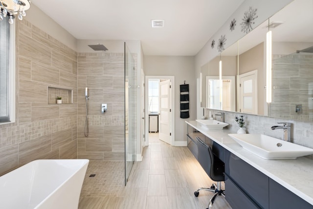 bathroom with vanity, tasteful backsplash, and shower with separate bathtub