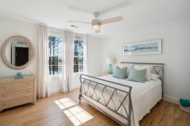 bedroom with ceiling fan and light wood-type flooring