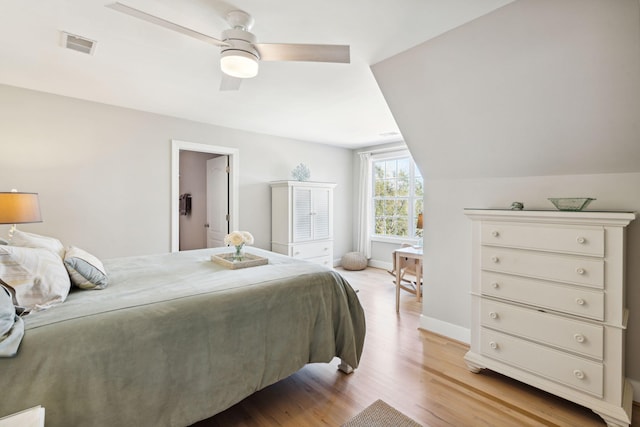 bedroom featuring ceiling fan, lofted ceiling, and light hardwood / wood-style floors