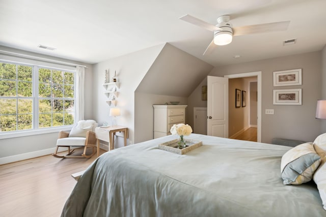 bedroom with ceiling fan, lofted ceiling, and light hardwood / wood-style floors