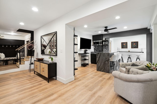 living room with ceiling fan and light hardwood / wood-style floors