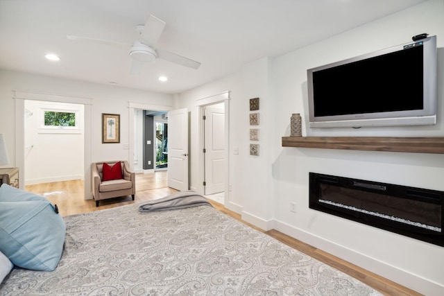 living room with ceiling fan and light wood-type flooring