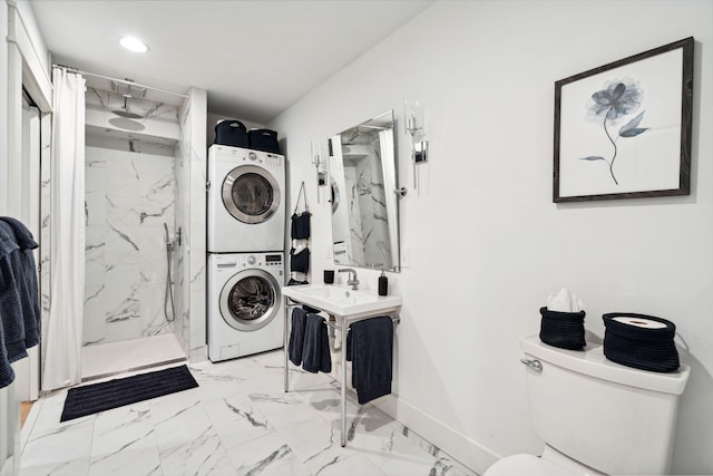 clothes washing area featuring stacked washer / drying machine