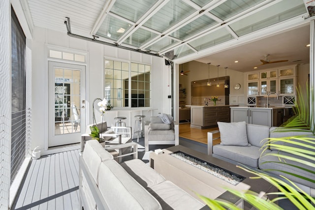 sunroom / solarium featuring ceiling fan