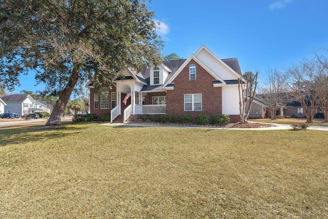 view of front facade featuring a front yard and brick siding