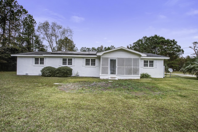 145 Buckeye Ct, Vance, SC 29163 - rear view of property featuring roof mounted solar panels, a lawn, and crawl space