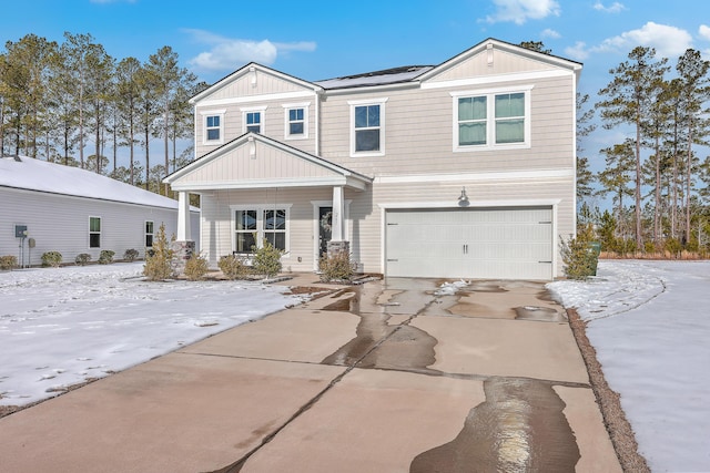 view of front of house with a garage, covered porch, and solar panels