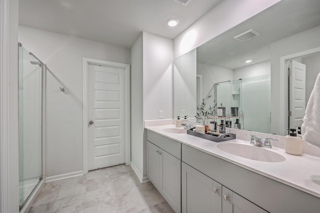 bathroom with vanity and a shower with shower door