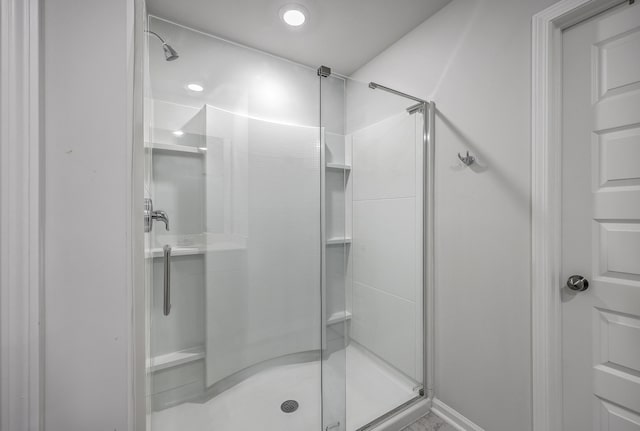 bathroom featuring a shower with shower door