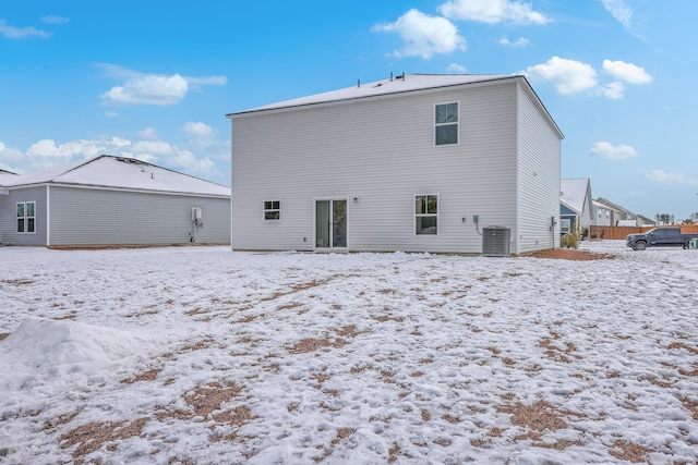 snow covered property with cooling unit