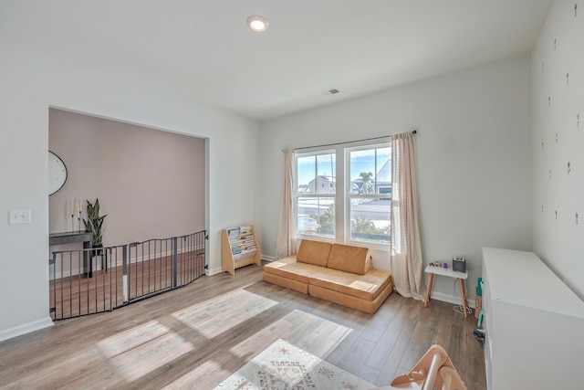 living area with light hardwood / wood-style flooring