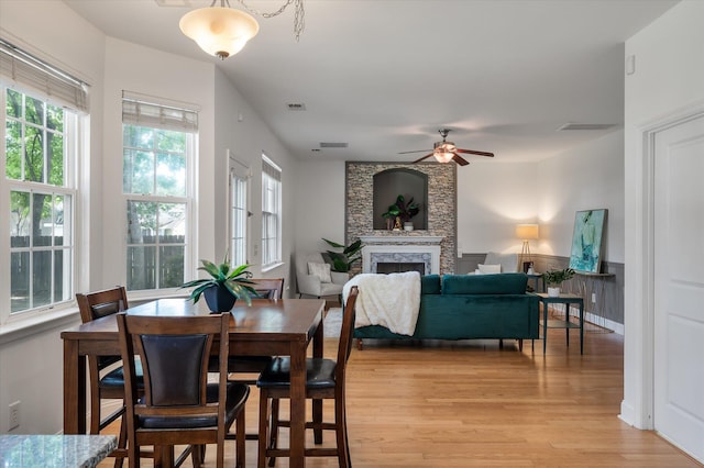 8328 Berringer Blf, North Charleston, SC 29418 - dining room with light wood finished floors, plenty of natural light, a large fireplace, and a ceiling fan