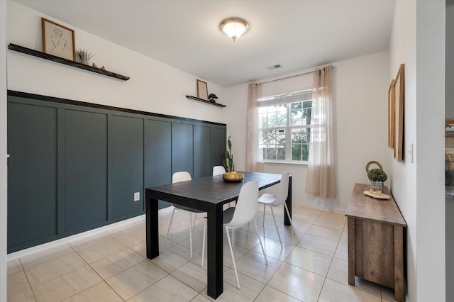 8328 Berringer Blf, North Charleston, SC 29418 - dining area with a decorative wall, light tile patterned floors, and wainscoting