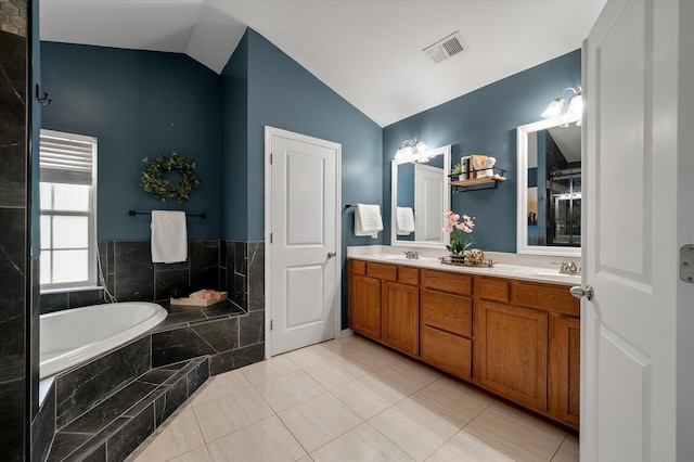 8328 Berringer Blf, North Charleston, SC 29418 - bathroom with lofted ceiling, a bath, double vanity, and tile patterned flooring