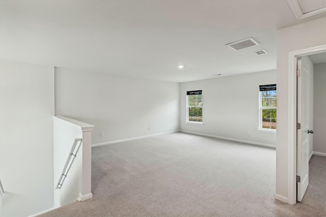 unfurnished room featuring light carpet