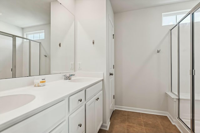 bathroom featuring vanity, walk in shower, and a wealth of natural light