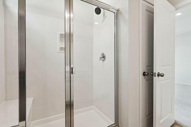 bathroom with a shower with door