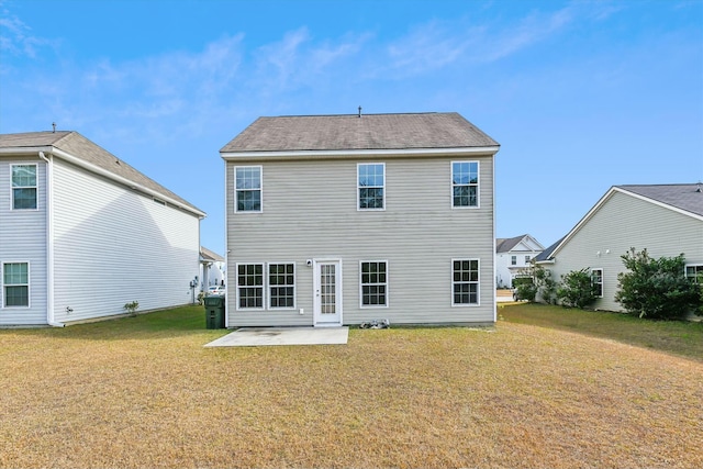 back of house featuring a lawn and a patio