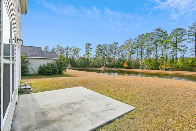 view of yard featuring a patio area and a water view