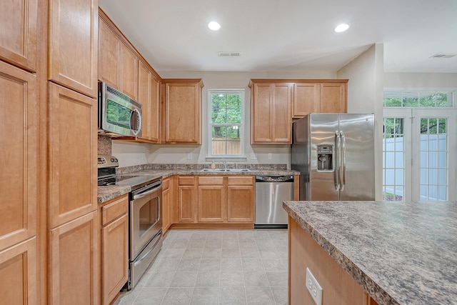 9646 Scarborough Ct, Summerville, SC 29485 - kitchen featuring appliances with stainless steel finishes, a sink, recessed lighting, stone counters, and light tile patterned floors
