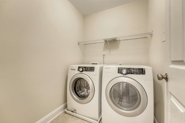 9646 Scarborough Ct, Summerville, SC 29485 - laundry room featuring washing machine and clothes dryer, light tile patterned floors, and baseboards