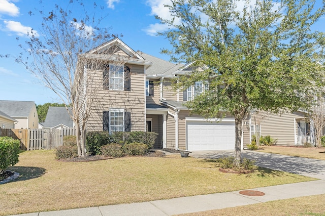 traditional-style house featuring driveway, a front lawn, an attached garage, and fence