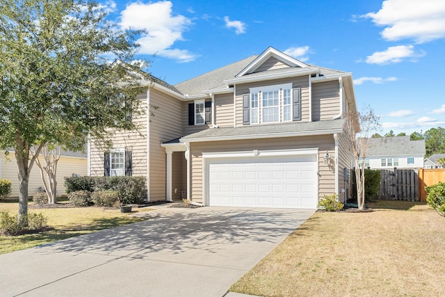 traditional home with a garage, driveway, a front yard, and fence