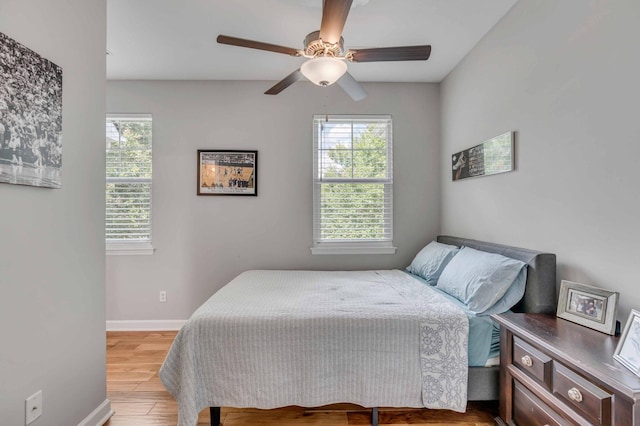 bedroom with light hardwood / wood-style floors and ceiling fan