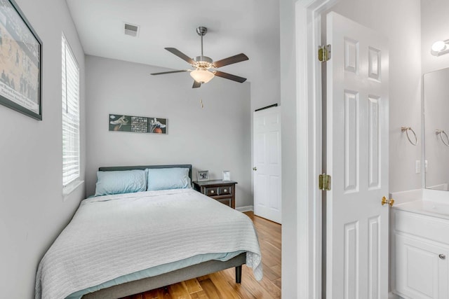 bedroom with light hardwood / wood-style floors and ceiling fan