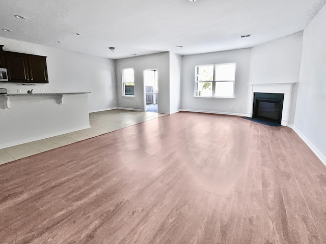 unfurnished living room with light hardwood / wood-style flooring