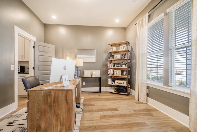 home office featuring recessed lighting, baseboards, and light wood finished floors