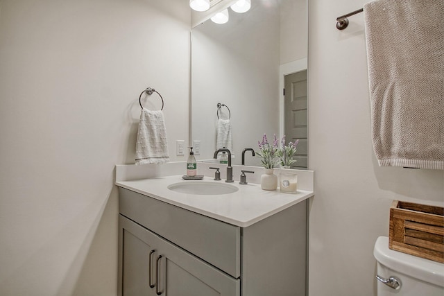 bathroom with toilet and vanity