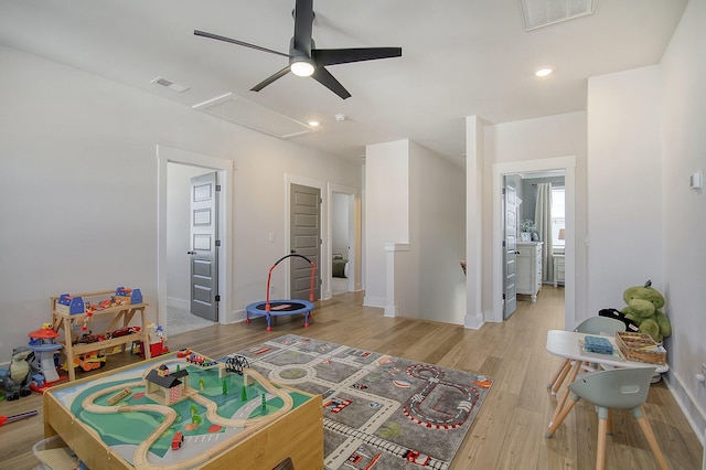 recreation room featuring visible vents, ceiling fan, baseboards, and wood finished floors