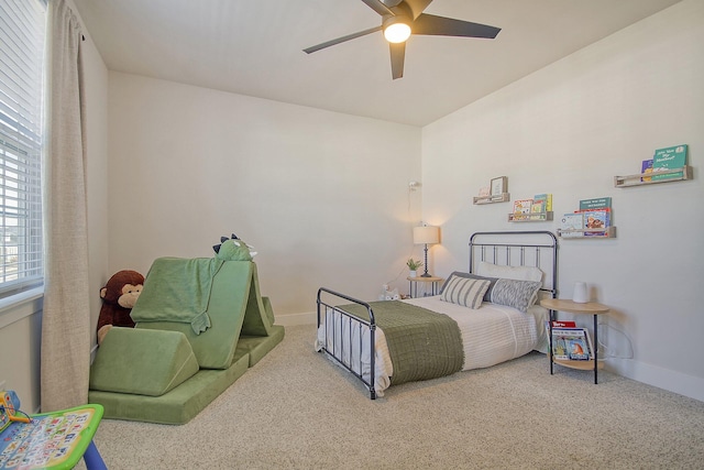 carpeted bedroom featuring baseboards and ceiling fan