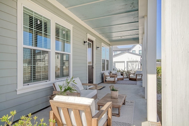 view of patio featuring a porch and an outdoor living space