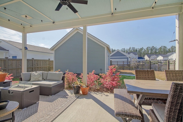 view of patio with a fenced backyard, outdoor dining space, an outdoor hangout area, and ceiling fan